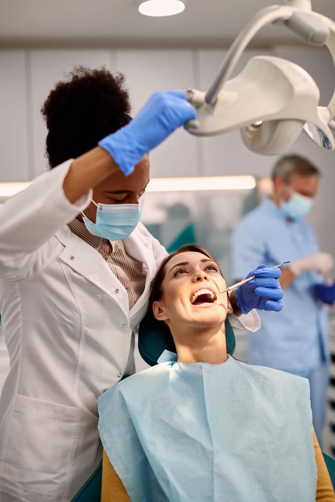 african-american-orthodontist-checking-lingual-bra-PV38WLX.jpg